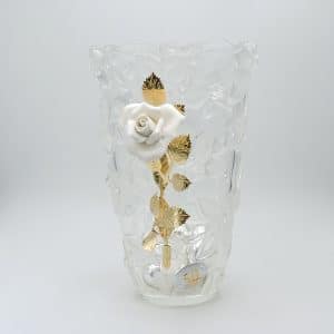 Crystal vase with a white rose and gold-leaf stems inside, decorative display piece