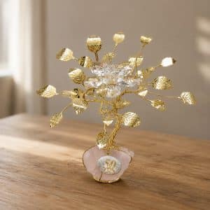Gold-toned decorative tree sculpture with crystal leaves on a pink stone base, commemorating a 50th anniversary.