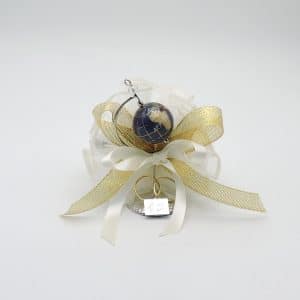 Wedding favor with white and gold ribbons, a blue globe charm, two gold rings, and a small silver tag.